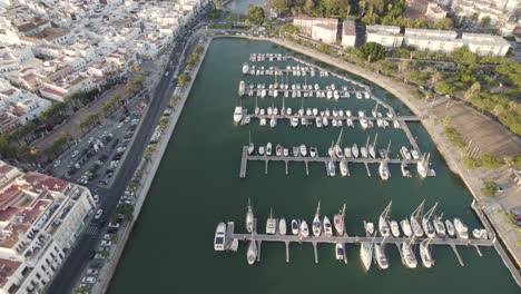 Boats-dock-at-Port-Ayamonte,-Spain,-Estero-de-la-Rivera,-drone-flyover