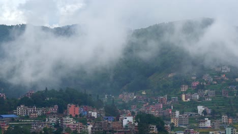 Clouds-drifting-over-the-mountains-and-into-the-lush-green-valley-and-over-the-small-town