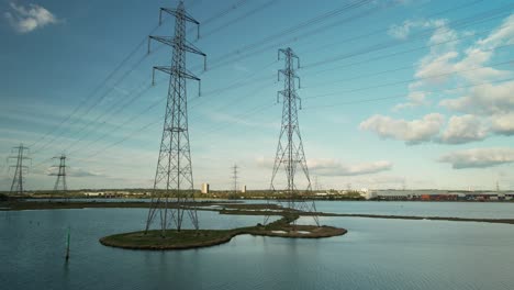 High-Voltage-Transmission-Towers-At-Eling-Great-Marsh-Along-River-Test-In-Southampton,-United-Kingdom