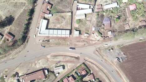 Aerial-top-down-view-of-a-rural-highway-through-the-village-of-Loitokitok,-Kenya