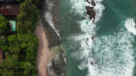 Foamy-Sea-Waves-Rolling-On-The-Shore-In-The-Tropical-Beach-Of-Sri-Lanka---aerial-top-down