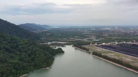 Coastal-coalfield,-industrial-ultra-supercritical-coal-fired-power-plant-next-to-the-mountain-located-at-lekir-bulk-terminal-jalan,-teluk-rubiah,-manjung,-perak,-malaysia