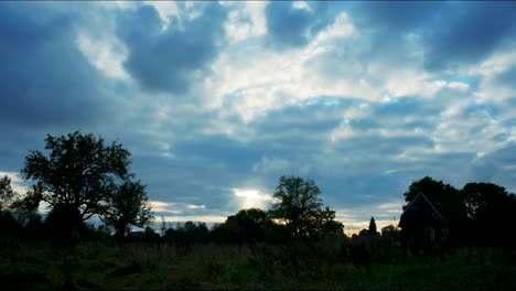 4K-timelapse-of-a-field-on-a-sunny-evening-with-a-cloudy-sunset