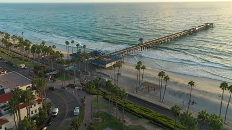 Aerial-spin-over-Avenida-Victoria-street-of-the-pier-in-San-Clemente-at-Sunset