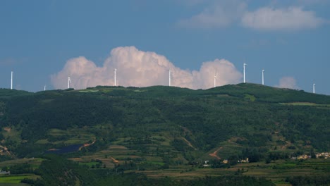 Drone-footage-of-large-electric-windmill-on-top-of-a-hill