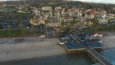 Aerial-reveal,-from-the-pier,-looking-inland-in-San-Clemente,-California