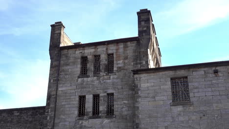 Medieval-style-building-with-barred-windows-and-battlements-at-Eastern-State-Penitentiary