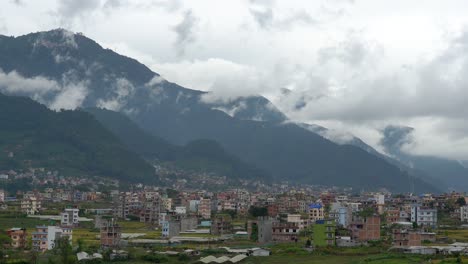A-view-of-Kathmandu-City-with-the-clouds-rolling-over-and-around-the-foothills-on-a-dreary-day-time-lapse