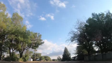 TIMELAPSE--In-the-middle-of-an-empty-street-in-a-small-town-called-Empress-Alberta-Canada-on-a-sunny-day-with-trees-and-buildings-around