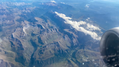 Stunning-footage-of-aerial-view-above-clouds-from-an-airplane-window-on-high-mountains