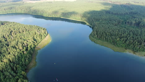 Aviris-lake-blue-water-with-sky-reflection-in-Lithuania,-high-angle-drone-view