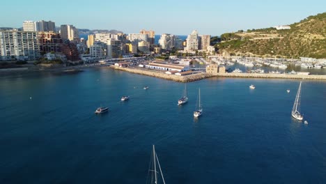 Drone-clip-flying-over-luxurious-yachts-and-boats-in-the-marina-of-the-coastal-city-of-Calpe-in-Spain