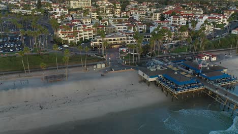 Slow-moving-aerial-view-of-the-base-of-the-pier-in-San-Clamente,-California