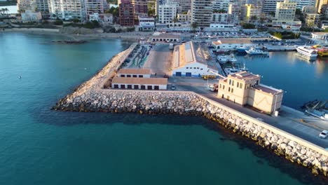 Drone-clip-over-the-wavebreaker-and-portside-buildings-in-the-marina-of-Calpe-town-in-Spain