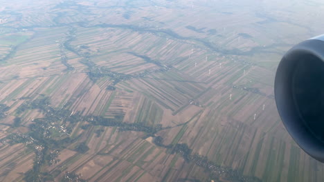 Aerial-View-Of-Wind-Farm-Through-Fog-From-Glass-Window-Of-Airplane-in-Flight
