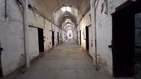 Moving-shot-of-prison-corridor-past-cells-at-Eastern-State-Penitentiary