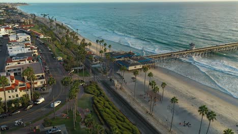 Slow-aerial-spin-over-the-pier-in-San-Clamente,-California-just-before-sundown
