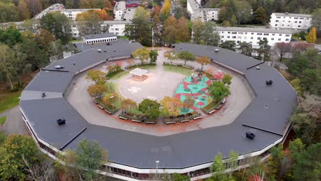 Aerial-View-Of-Round-shaped-School-Building-With-Contemporary-Exterior-At-Daytime