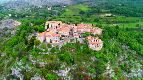 Aerial-view-showing-rural-village-of-gourdon-with-old-buildings-located-in-hill-in-France
