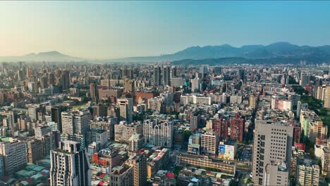 Aerial-Panoramic-shot-showing-big-city-of-Taipei-in-the-morning---Beautiful-city-scene-with-colorful-lights-and-mountains-in-backdrop---4k-drone-shot-with-dji-mavic-pro-3---Asia,Taiwan