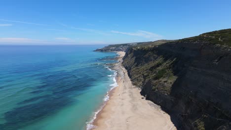 Aerial-view-of-an-amazing-deserted-beach-surrounded-by-cristal-clear-waters-and-amazing-cliffs