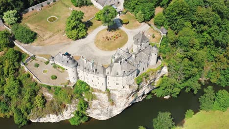 Renovated-Chateau-atop-cliff,-besides-flowing-river