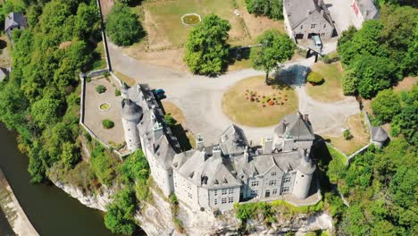 Renovated-Chateau-atop-cliff,-besides-flowing-river