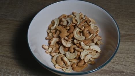 Zoom-out-of-the-Cashew-Nuts-in-a-bowl,-a-healthy-source-of-protein-and-energy-food