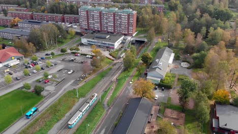 Aerial,-tram-arriving-at-station-in-Gardsas-Torg