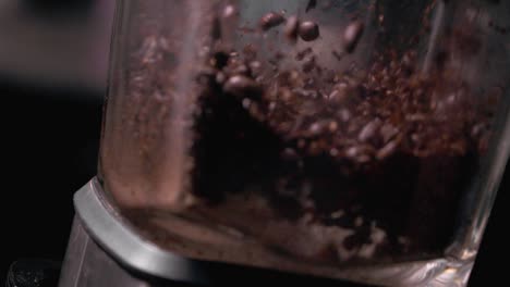Super-slow-motion-of-coffee-beans-being-ground-in-a-high-speed-blender