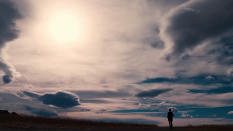 Striking-black-silhouette-outline-of-a-male-jogger,-jogging-against-a-dramatic-sky