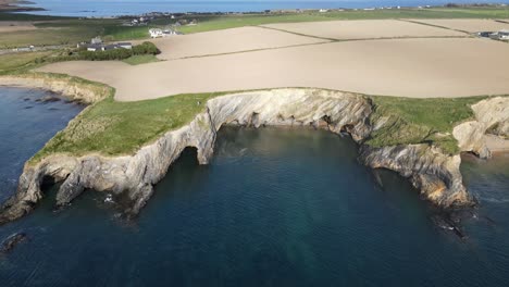 Rugged-coast-of-West-Cork,-with-coves,-cliffs-and-farm-fields,-an-aerial-footage