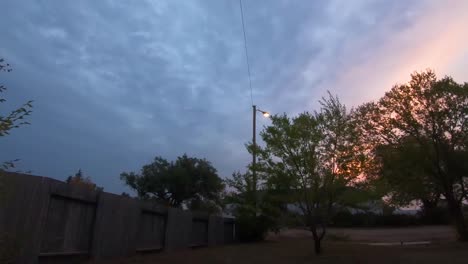 TIMELAPSE---Spooky-night-on-Halloween-watching-dark-clouds-flow-over-a-small-yard-in-the-country