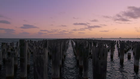 Beautiful-sunset-at-princess-pier's-wooden-pylons-with-slow-moving-clouds-in-the-sky