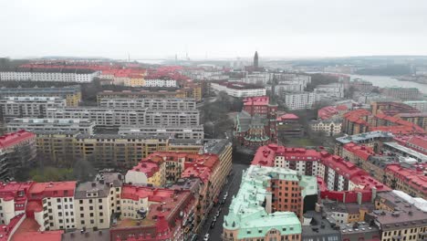 Stunning-aerial-flying-towards-Oscar-Fredrik-Church-surrounded-by-skyline-and-buildings-on-a-cloudy-and-rainy-winter-day-in-Gothenburg-City,-Sweden