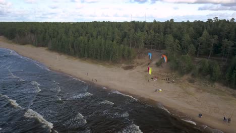 Paragliders-hovering-on-the-beach-in-Latvia,-outdoor-activity
