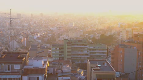 Handheld-shot-of-the-sunset-and-misty-skies-of-a-little-village-on-the-hillside-of-Barcelona