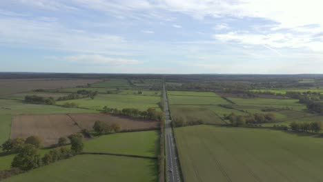 Long-Straight-Road-Between-Countryside-Field-At-Daytime