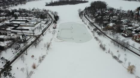 People-Playing-Ice-Hockey-on-Frozen-Pond-in-Winter