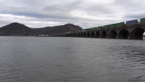 A-train-crossing-a-stone-bridge-over-the-Susquehanna-River-near-Harrisburg,-Pennsylvania
