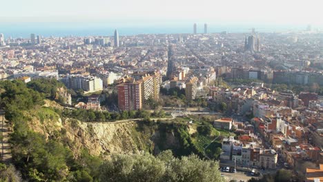 Handheld-shot-looking-down-at-the-city-of-Barcelona-during-the-start-of-golden-hour