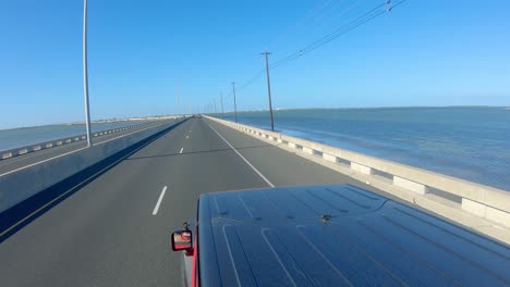 POV-from-rooftop-of-vehicle-crossing-Queen-Isabella-Causeway-bridge-across-Laguna-Madre-on-a-sunny-afternoon