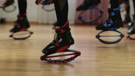 Sports-girls-train-jumping-on-boots-Кangoo-jumps