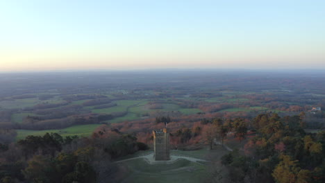 Smooth-aerial-drone-footage-at-Leith-Hill-tower-in-the-Surrey-Hills,-in-the-English-countryside