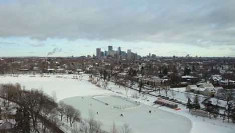 People-Skating-on-Frozen-Pond-with-Minneapolis-Skyline-in-Background