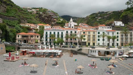 Traditional-Portuguese-buildings-on-seaside-boulevard-at-Ponta-do-Sol,-aerial