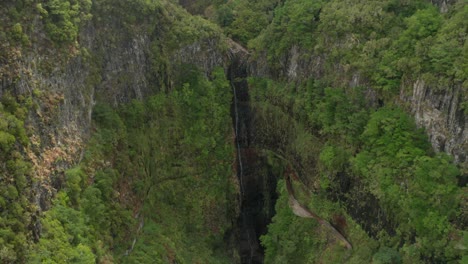 Aerial-of-scenic-Risco-waterfall-in-lush-canyon-of-Madeira-island