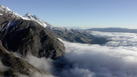 Pico-De-Shanzidou-De-La-Montaña-Del-Dragón-De-Jade-Que-Se-Eleva-Por-Encima-De-Las-Nubes,-Yunnan-China,-Antena-4k
