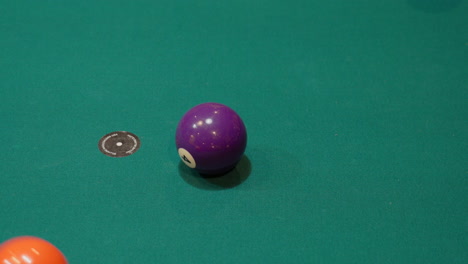 Pool-Balls-are-Broken-on-a-9-Ball-Diamond-Rack-Closeup-on-the-Spot-with-Solid-and-Striped-Billiard-Balls-Scattering-Across-the-Table-with-Green-Felt-or-Cloth,-Break-View-From-Above