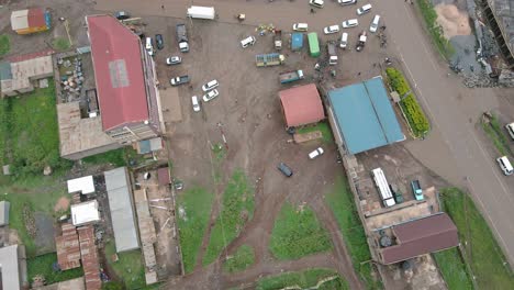 Top-Down-View-Of-Streets-With-Houses-And-Vehicles-In-The-Rural-Town-Of-Loitokitok-In-Kenya-At-Daytime---aerial-drone-shot